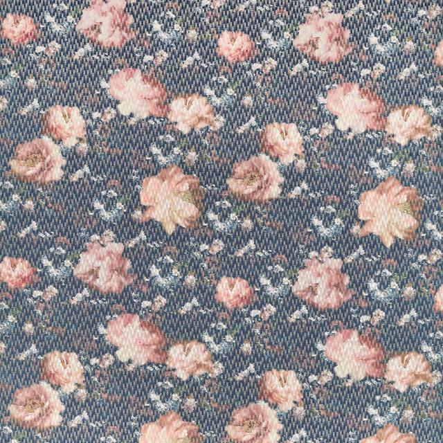 Dusky blue woven fabric with scattered blush pink and peach flowers