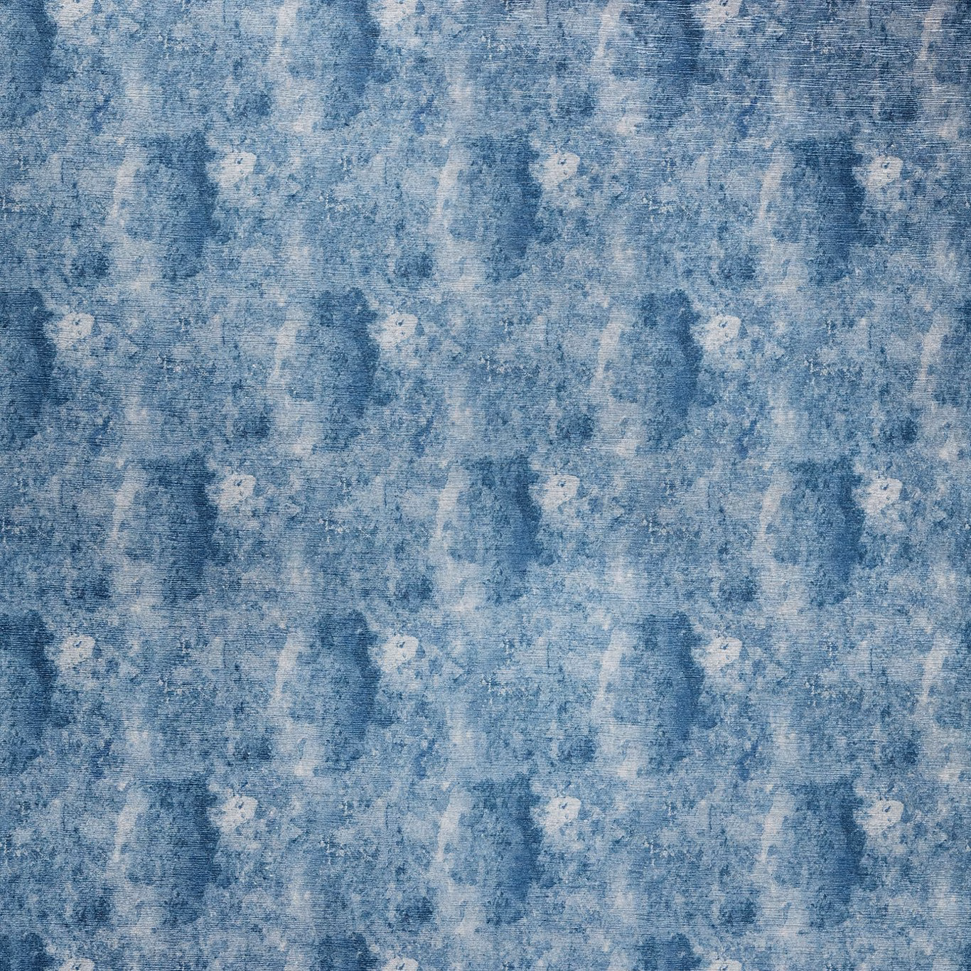 Mottled midnight blue fabric with pale chalky flecks and textured painterly marks