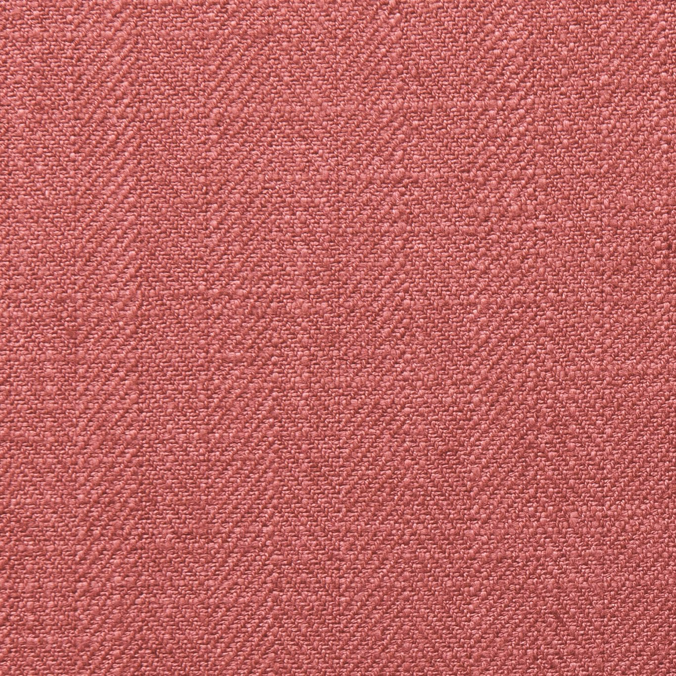 Close-up of dusty garnet red fabric with a fine irregular woven texture