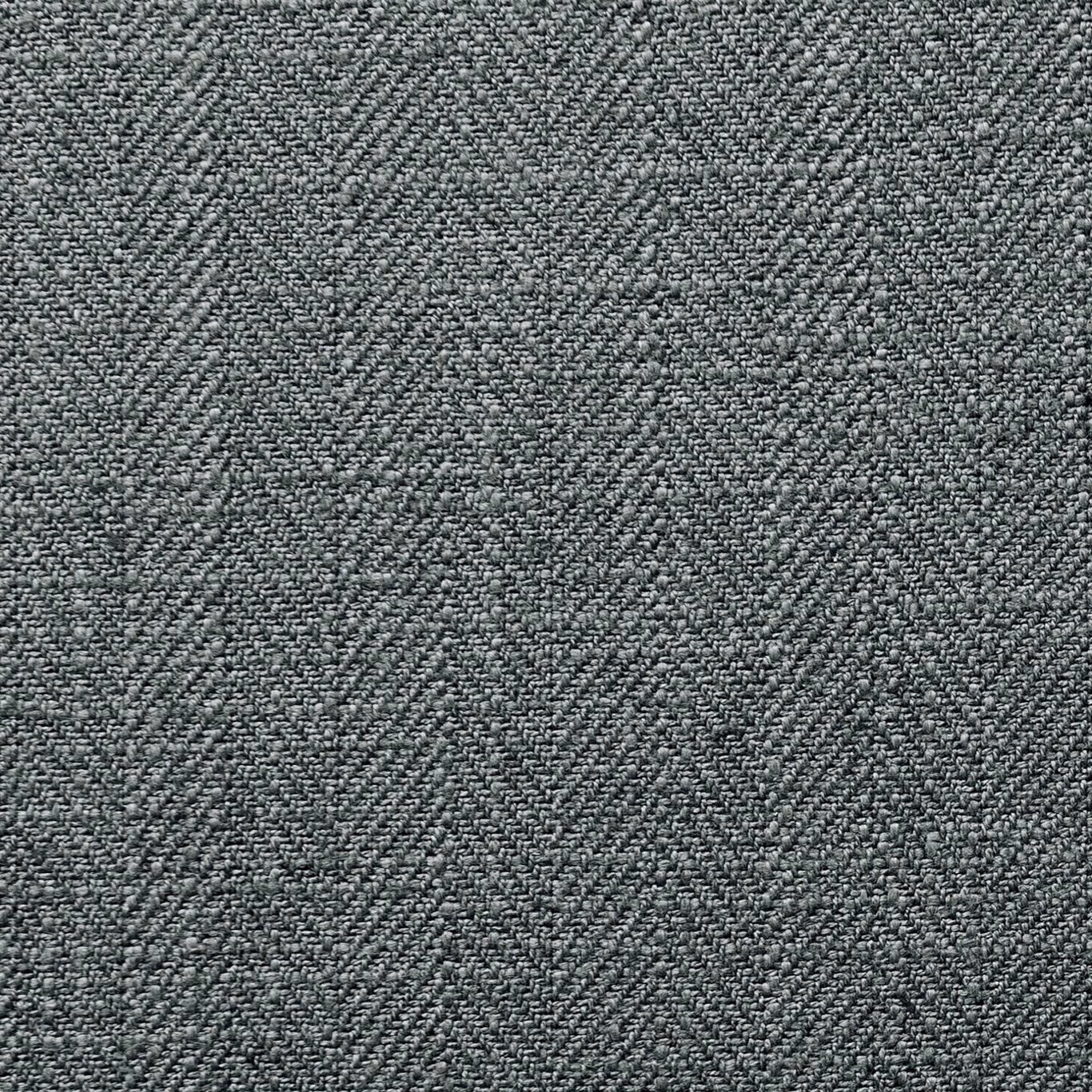Close-up of cool steel-grey fabric with a dense, finely pebbled woven texture