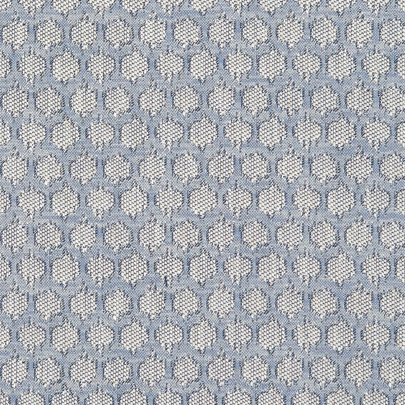 Muted denim-blue woven fabric with repeated cream floral medallions and tactile flecked texture