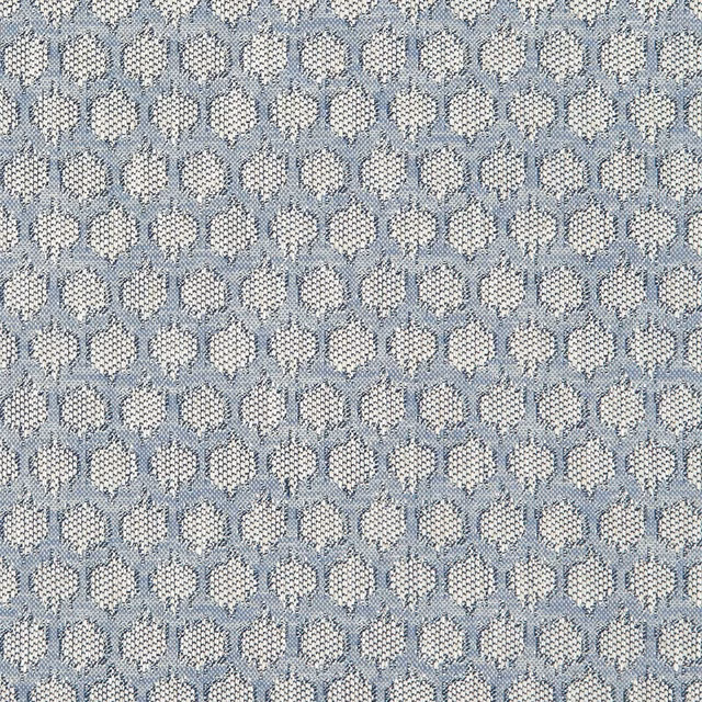 Muted denim-blue woven fabric with repeated cream floral medallions and tactile flecked texture