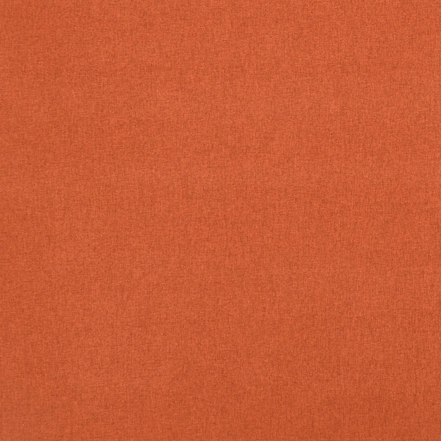 Close-up of warm flame-orange fabric showing a fine plain weave and subtle tonal texture