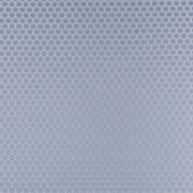 Soft blue-grey woven textile with tiny linked oval motifs and tactile surface