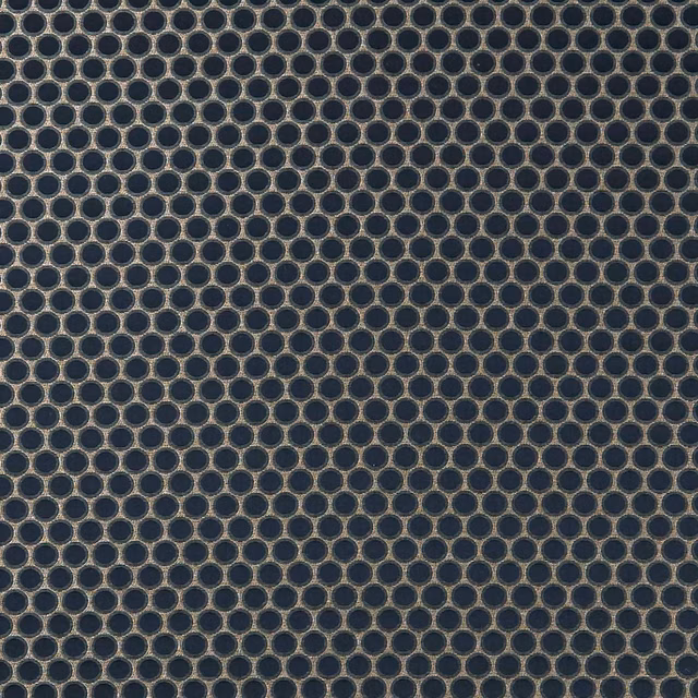 Charcoal woven upholstery with dense bronze-taupe circular rings and textured surface