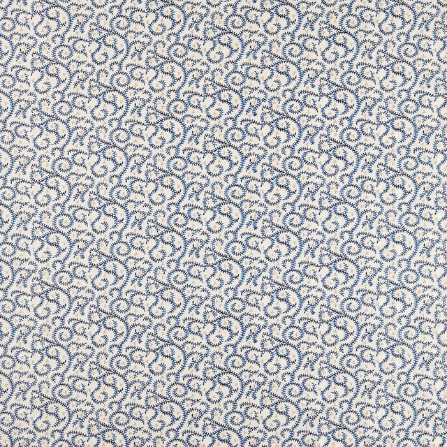 Cream fabric densely covered in small cool ink-blue curled buta embroidery motifs
