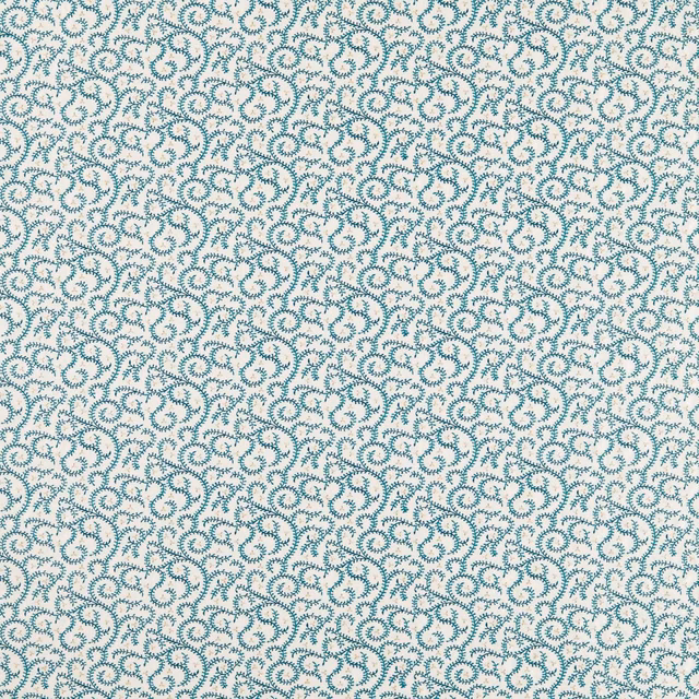 Dense teal curling buta embroidery scattered across an ivory fabric ground