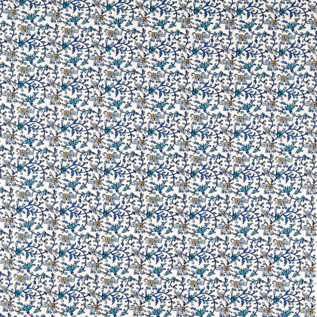Ivory textile with cobalt branching vines, teal leaves and tiny elephant motifs