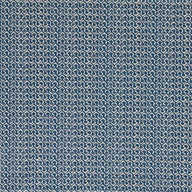 Ink-blue woven ground with dense cream interlocking geometric motifs