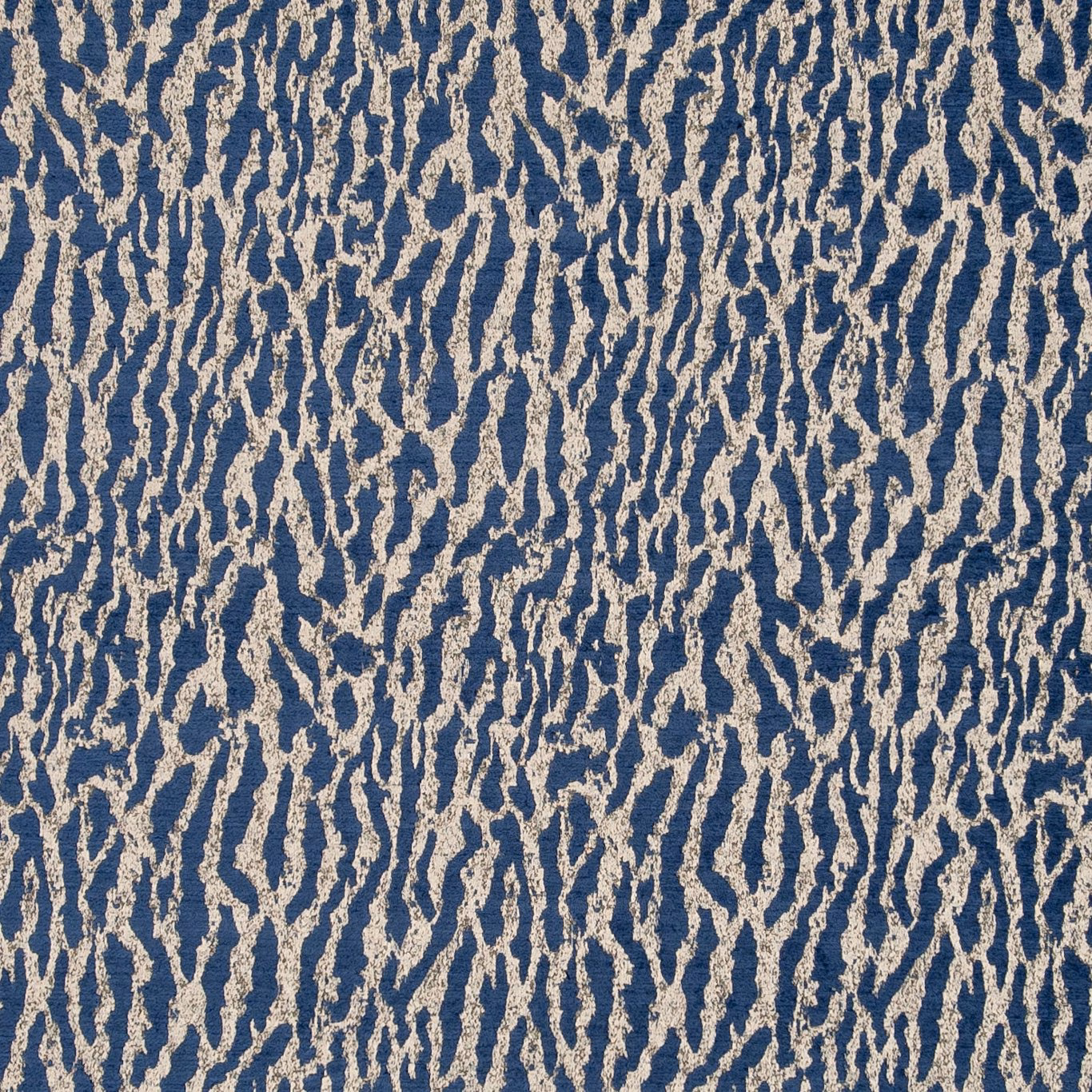 Deep indigo woven upholstery fabric with irregular oatmeal vertical striations and tactile texture