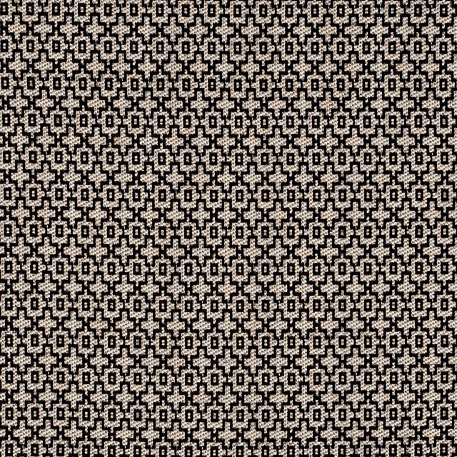 Dense charcoal and ivory geometric woven fabric with tiny stepped motifs