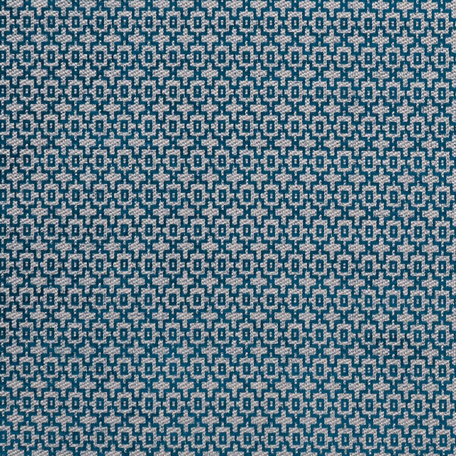 Close view of teal and pale geometric interlocking motifs in a textured weave