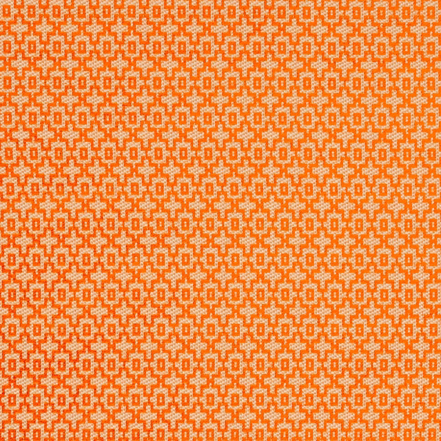 Spice-orange woven fabric with pale oatmeal stepped geometric motifs