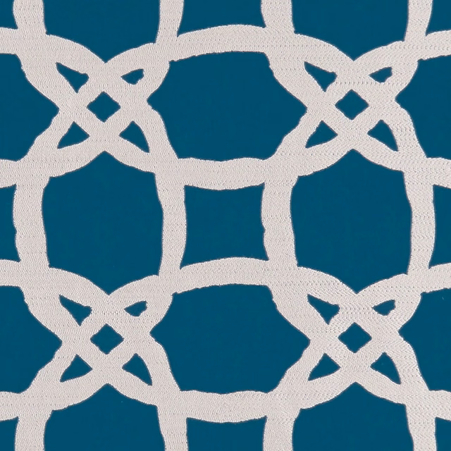 Deep kingfisher teal woven ground with an ivory interlocking lattice motif