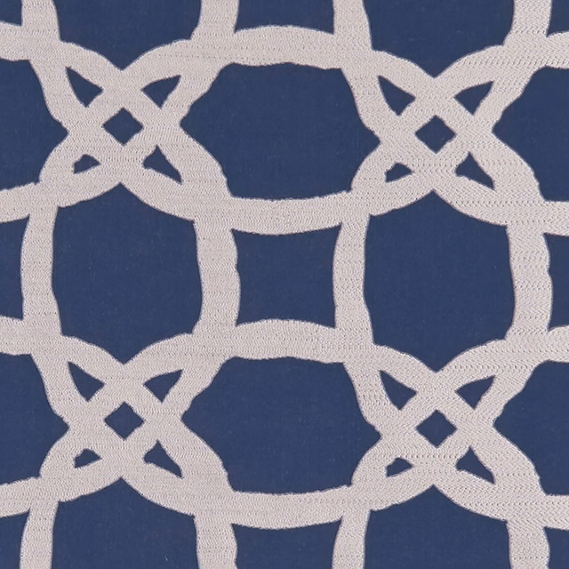 Midnight blue woven fabric with ivory interlocking lattice and diamond details