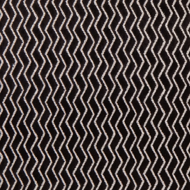 Deep ebony textile with crisp ivory zigzag rows and a tactile surface
