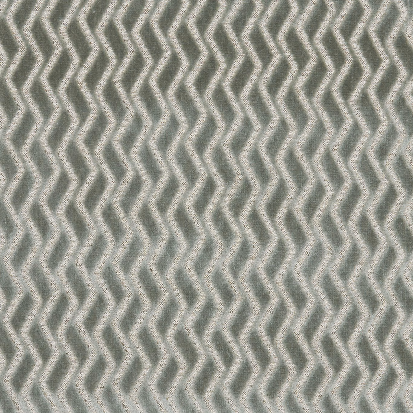 Close-up of muted mineral grey-green fabric with tactile repeating zigzag lines
