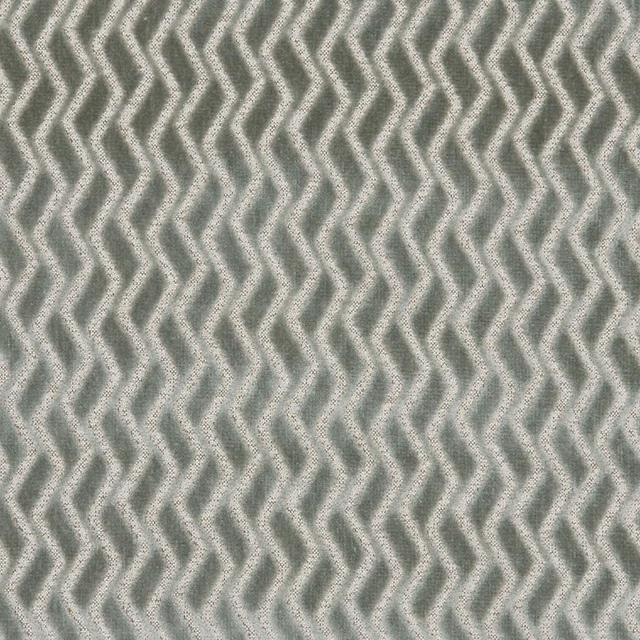 Close-up of muted mineral grey-green fabric with tactile repeating zigzag lines