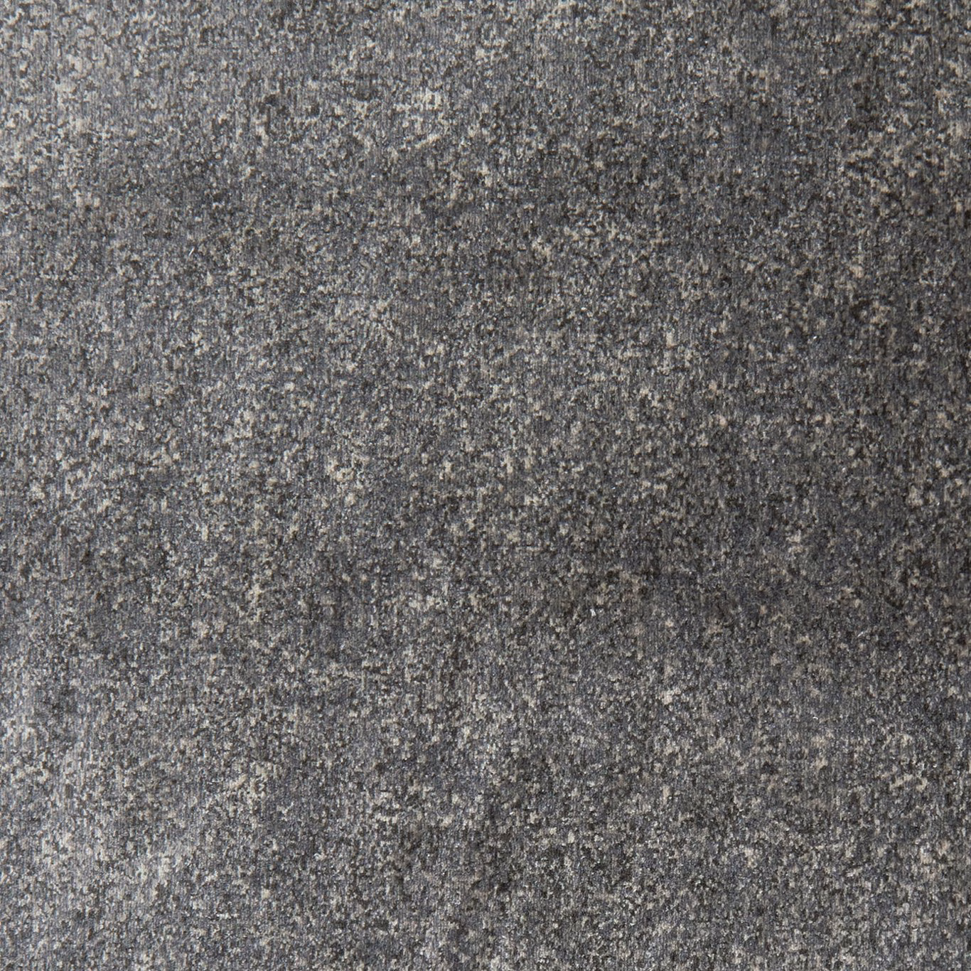 Close-up of charcoal grey woven fabric with pale flecks and mottled graphite texture