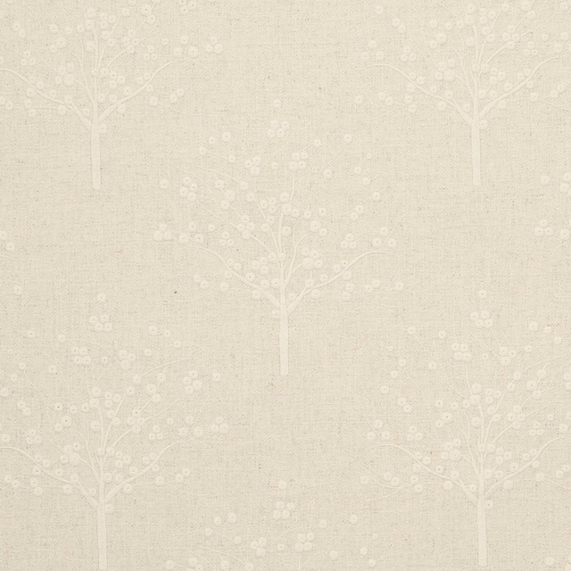 Warm beige woven fabric with pale flowering tree motifs and scattered blossom dots