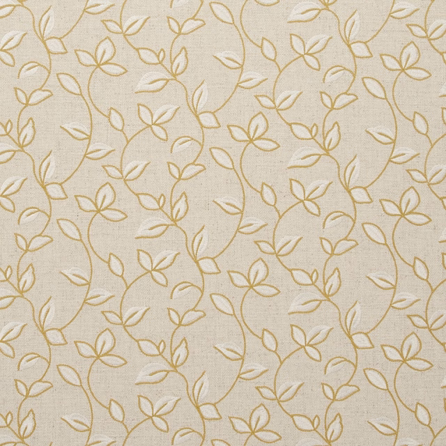 Warm ivory woven fabric with delicate antique-gold botanical stems, leaves and open flowers