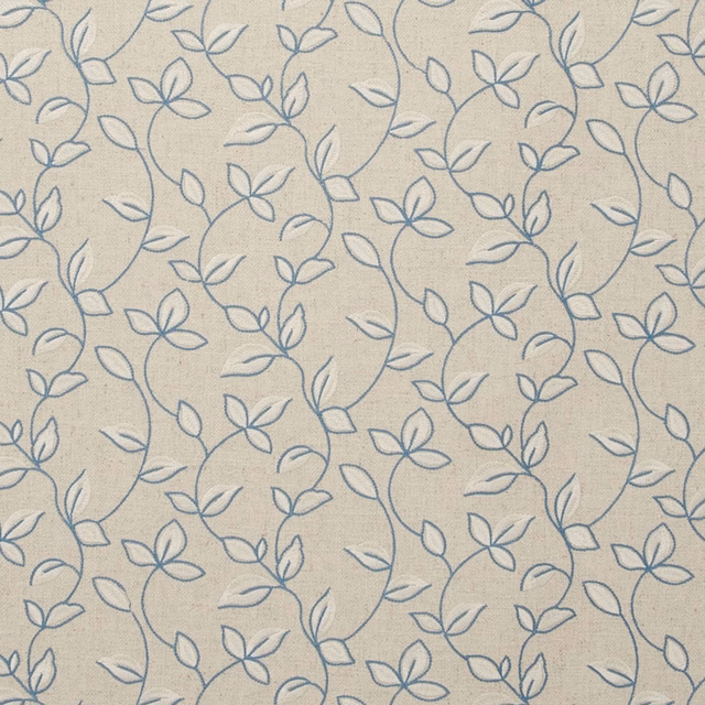 Warm beige woven ground with muted blue looping vines and outlined flowers