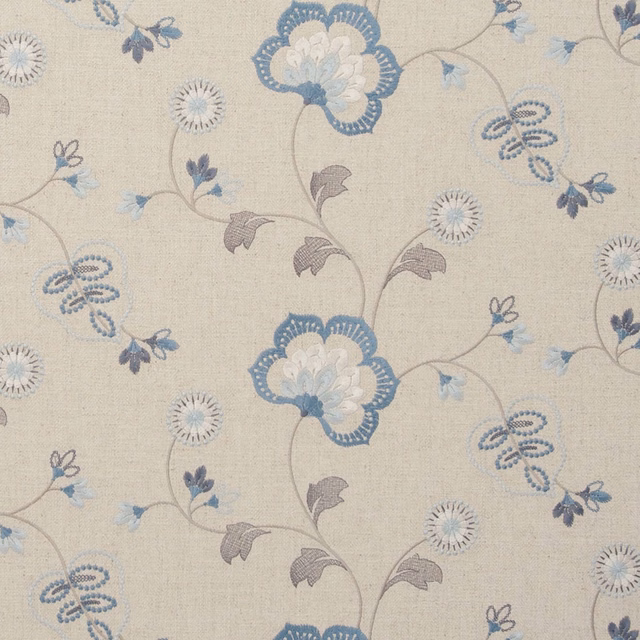 Pale blue floral vines and taupe leaves woven across a soft beige ground