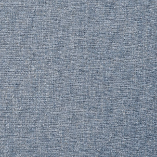 Mottled chambray-blue woven textile with fine pale crosshatch texture