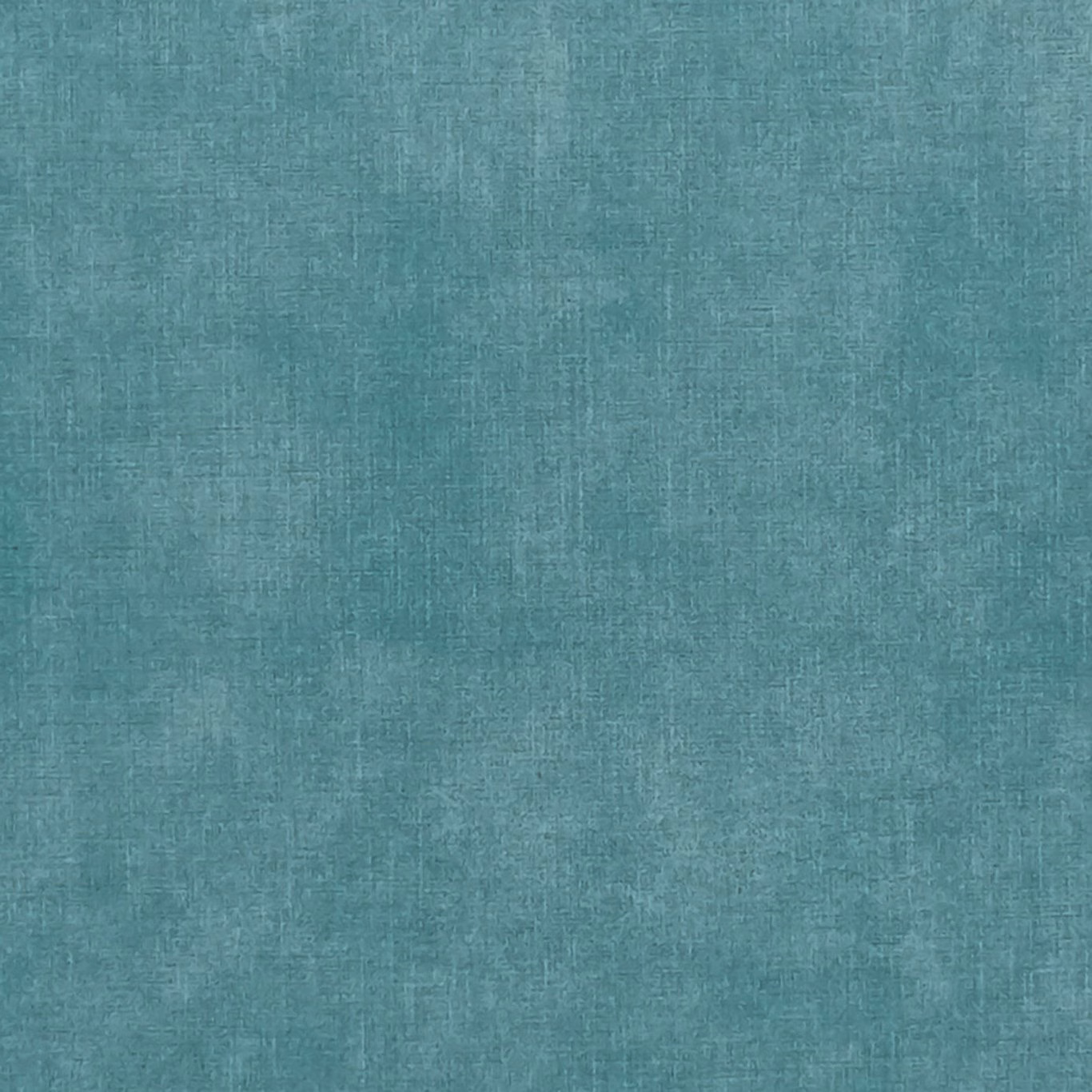 Close-up of muted teal denim-blue woven textile with softly mottled crosshatch texture