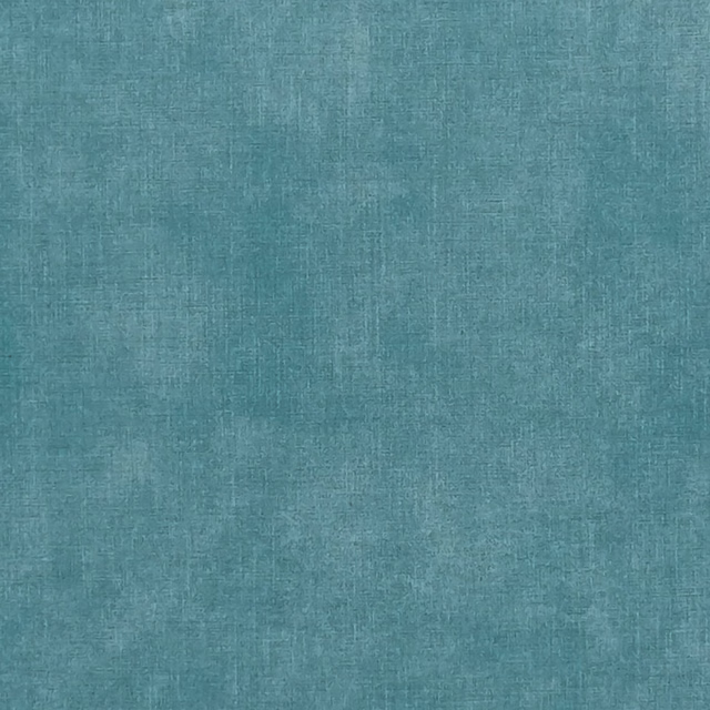 Close-up of muted teal denim-blue woven textile with softly mottled crosshatch texture