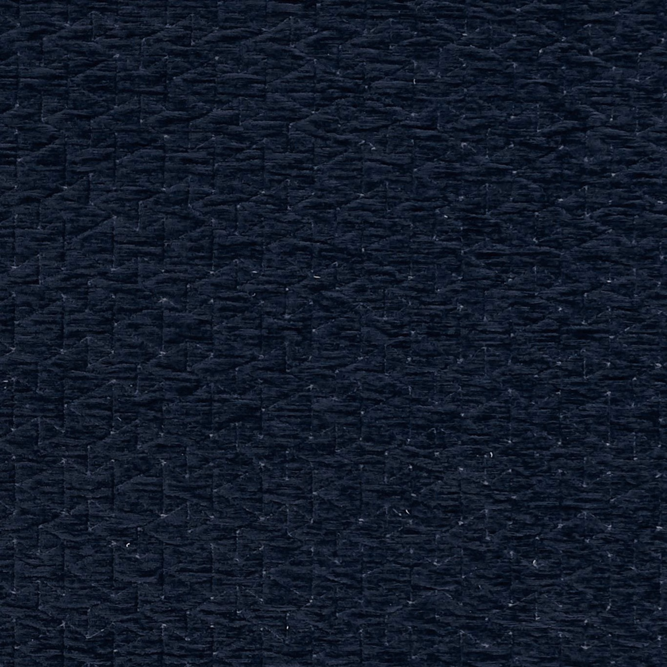 Close-up of near-black navy woven fabric with irregular raised slub texture