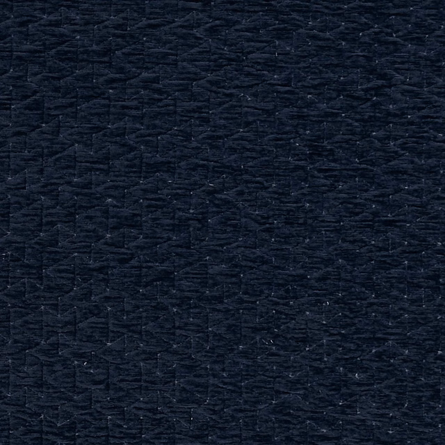 Close-up of near-black navy woven fabric with irregular raised slub texture