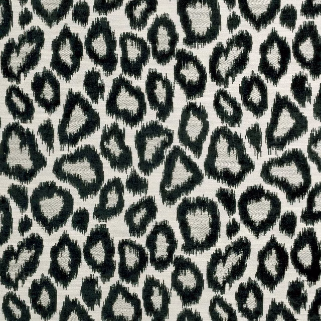 Ivory woven ground with irregular black leopard-like rings and softly frayed edges
