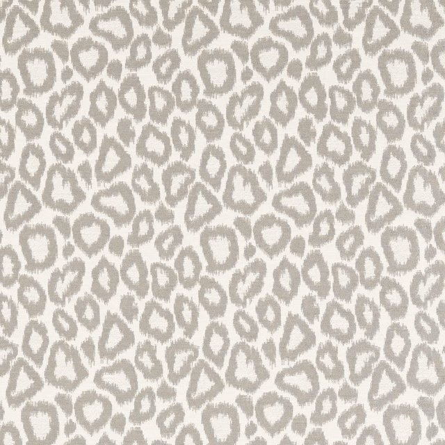 Warm ivory textile with dense soft slate-grey irregular spot motifs and lightly nubby surface