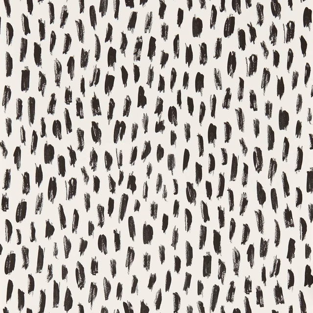Ivory wallpaper with scattered uneven noir brushstroke marks and painterly texture