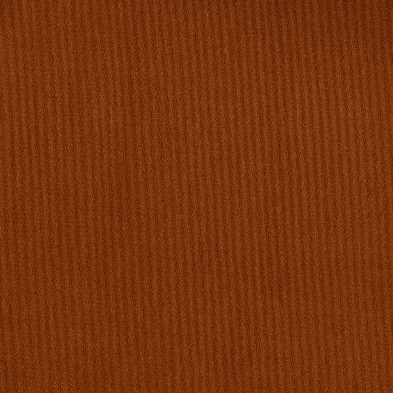 Close-up of warm amber terracotta plain fabric with a softly textured surface