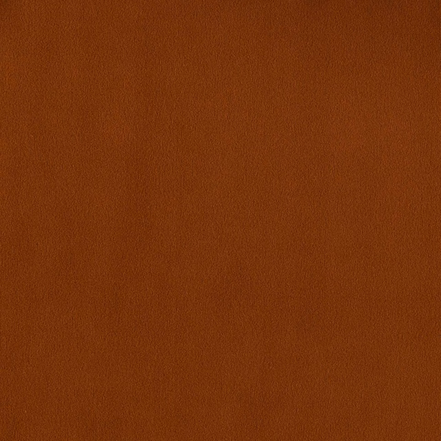 Close-up of warm amber terracotta plain fabric with a softly textured surface