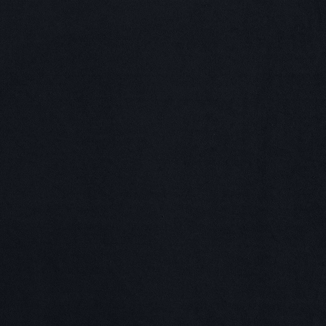 Deep ebony-black textile swatch with subtle mottled weave and softly shifting surface texture