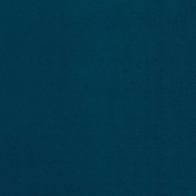 Deep blue-teal fabric with subtle nap and softly shifting surface texture