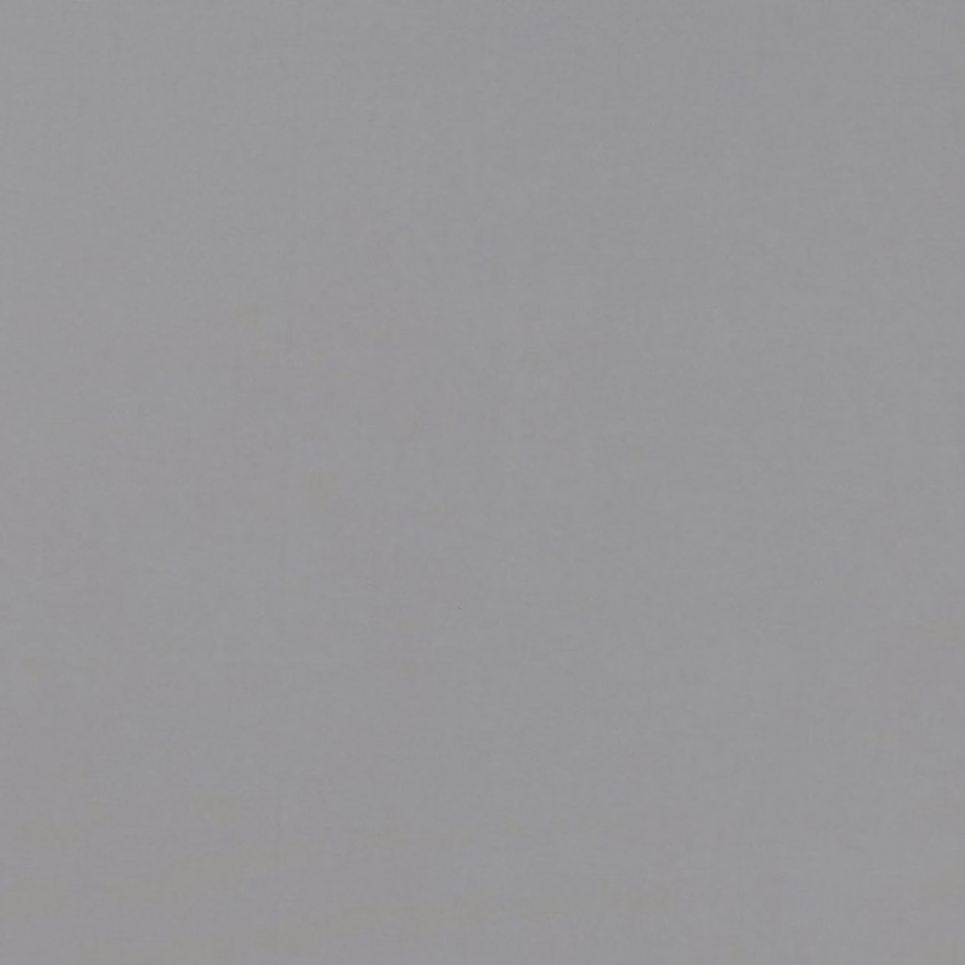 Close-up of cool pewter-grey plain weave with a softly mottled surface