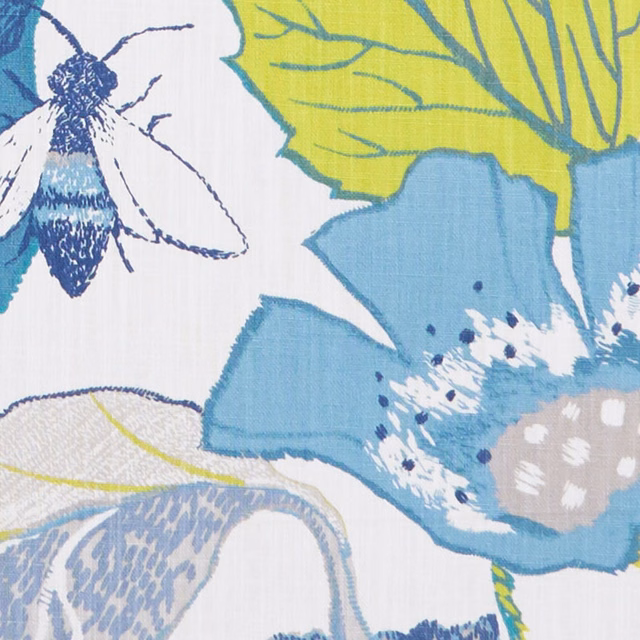 Denim-blue flowers and apple-green leaves with navy insect on a white botanical fabric