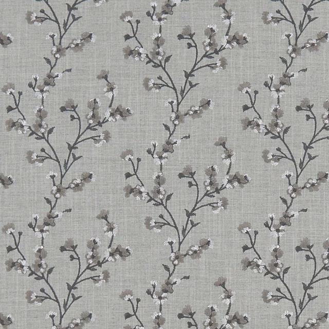 Cool grey woven ground with charcoal flowering branches and tiny pale blossoms