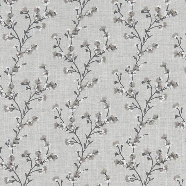 Pale silver-grey woven fabric with branching charcoal stems and soft blossom sprigs