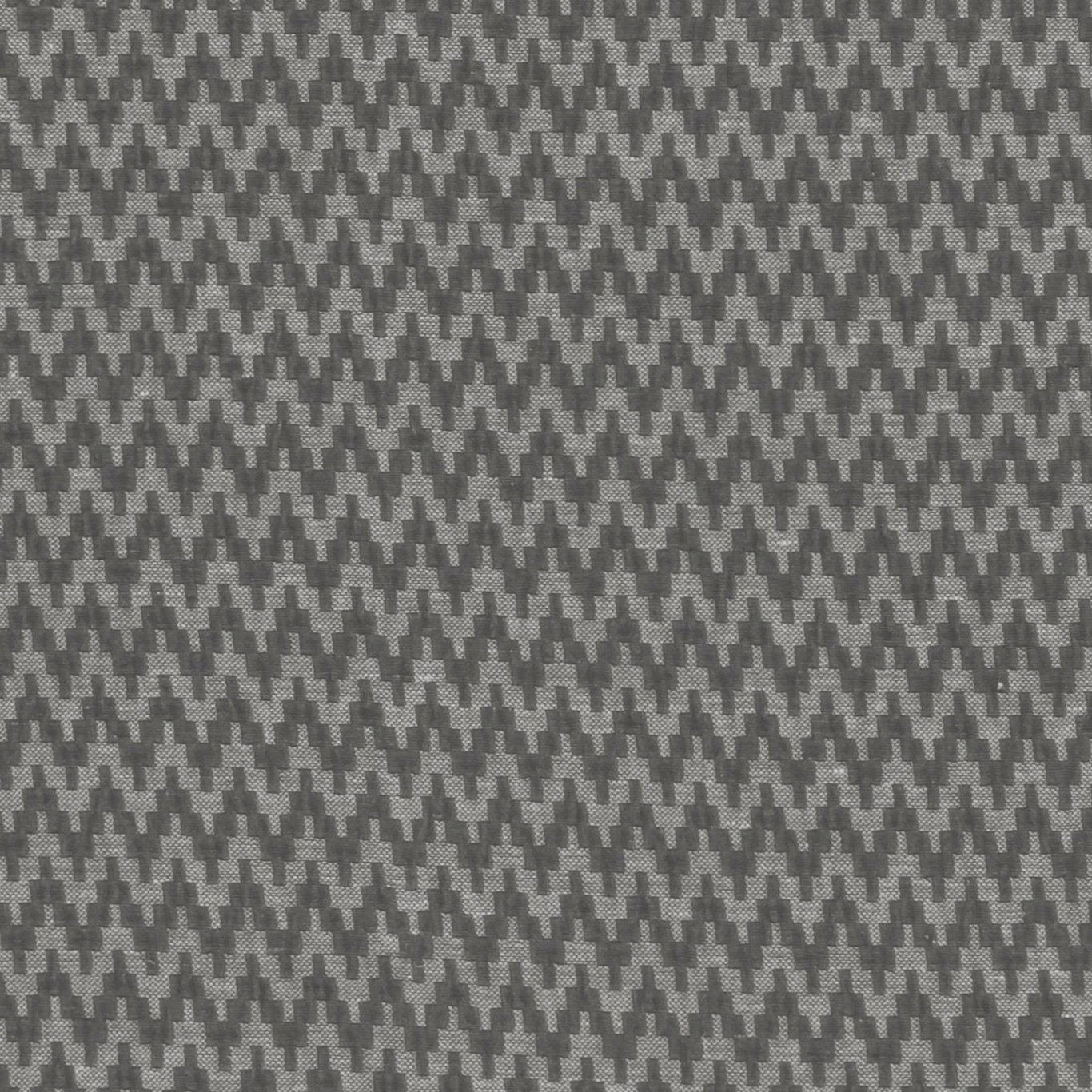 Close-up of charcoal grey woven fabric with small stepped geometric motifs