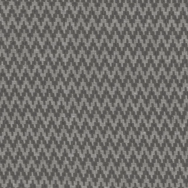 Close-up of charcoal grey woven fabric with small stepped geometric motifs