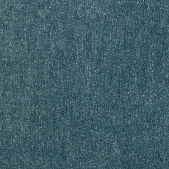 Close-up of cool blue teal Maculo Arctic with mottled vertical texture and fine pale flecks