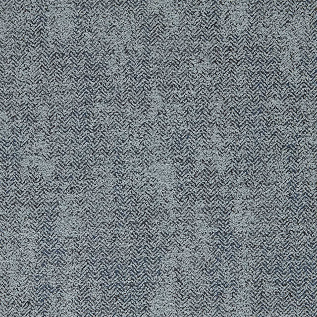 Muted denim-blue woven chevrons with charcoal flecks and softly mottled texture