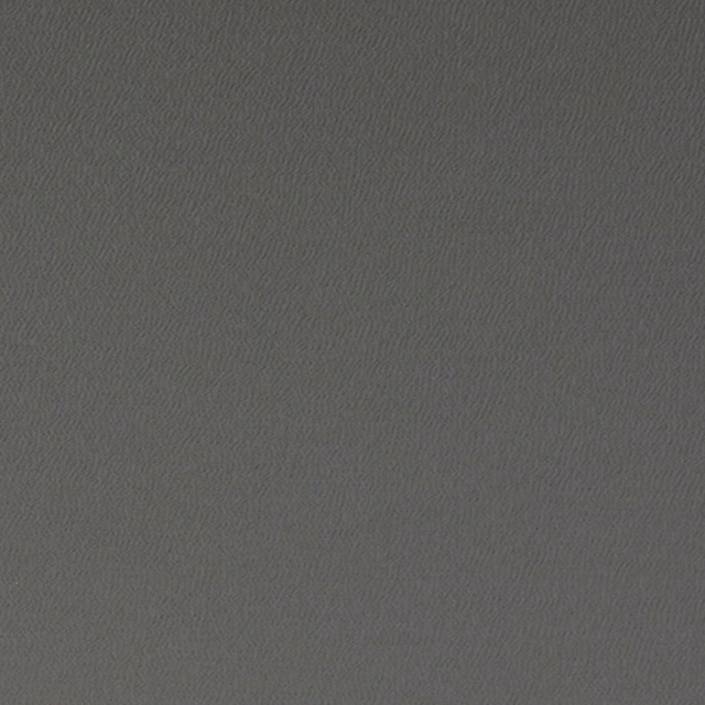 Close-up of deep charcoal grey fabric with a fine, subtly rippled woven texture