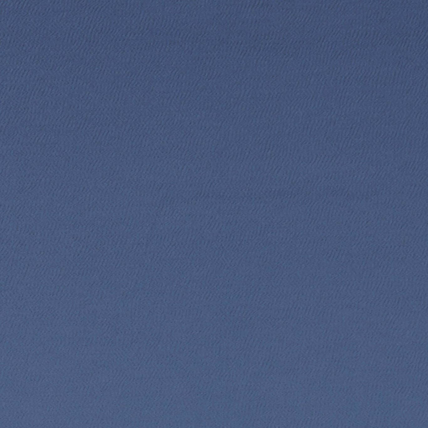 Muted denim-blue textile showing a fine tonal chevron-like woven texture