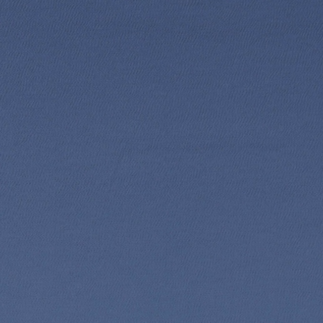 Muted denim-blue textile showing a fine tonal chevron-like woven texture